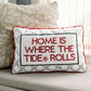 Decorative pillow with 'Home is where the tide rolls' text on a couch.
