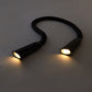 Flexible gooseneck hands-free book light on table with amber light mode on